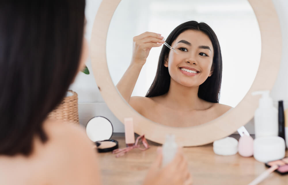 Woman applying face serum