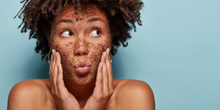 Woman exfoliating face