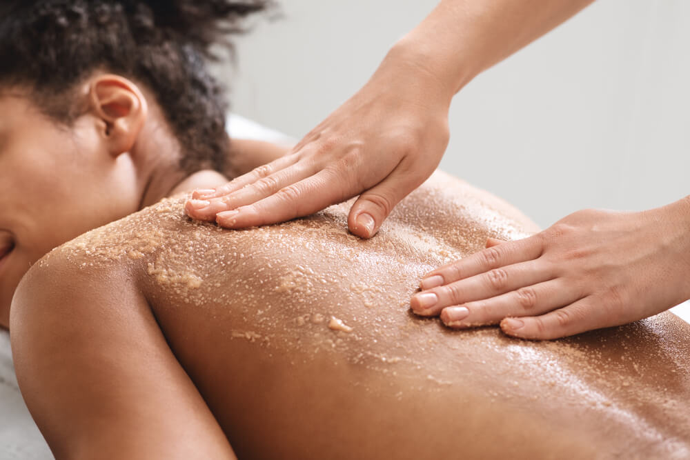 Woman exfoliating back