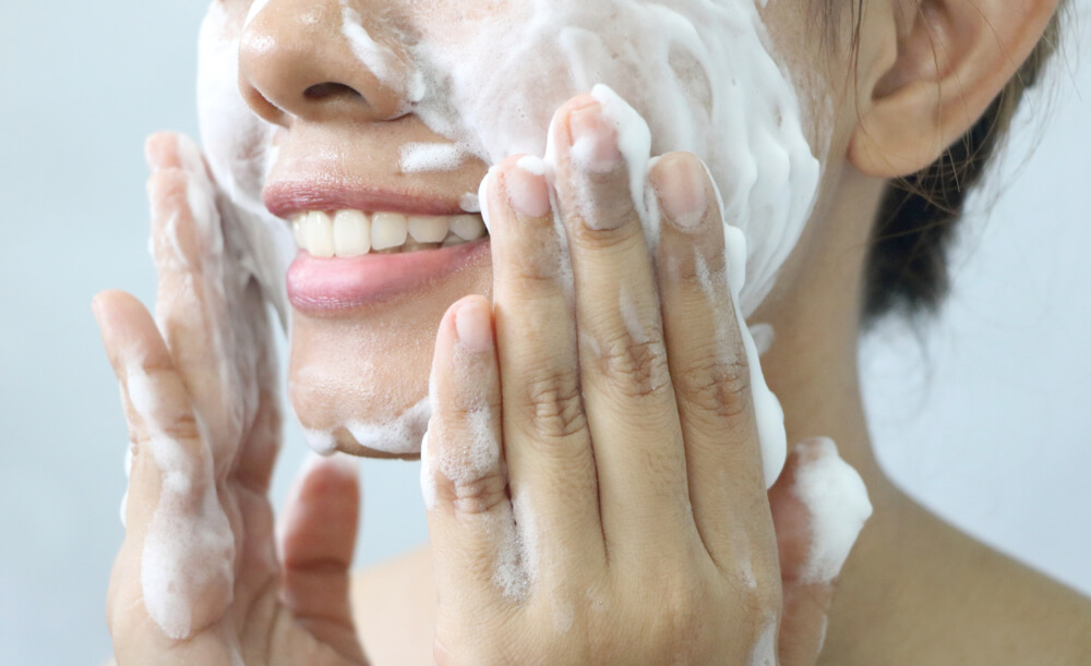 Woman cleansing skin