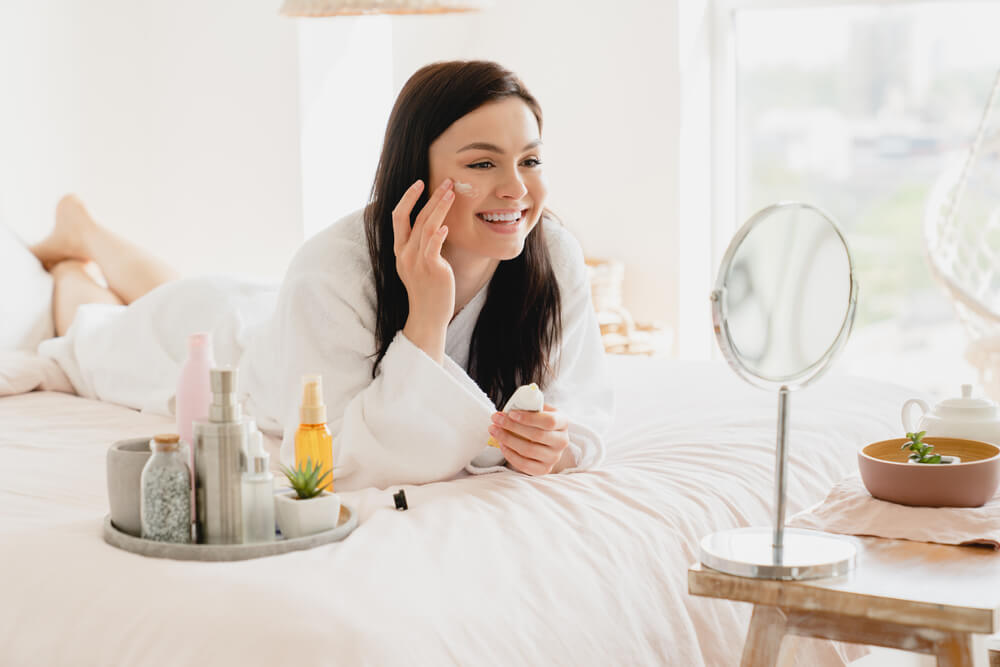 Woman applying face cream