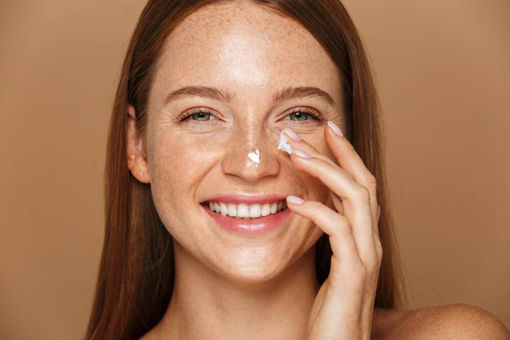 Woman applying day moisturizer