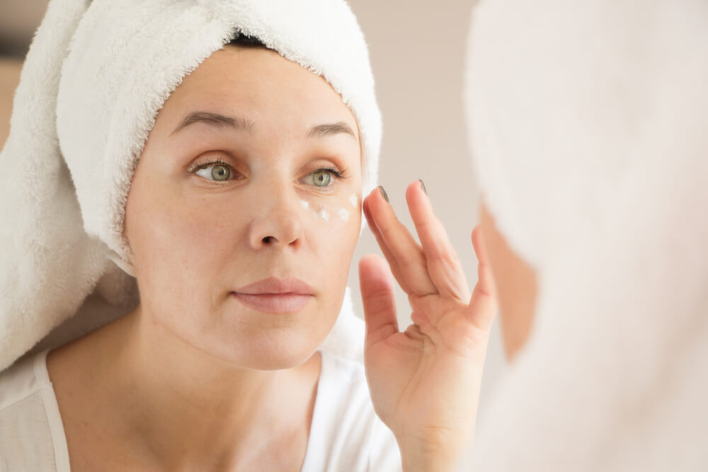 Woman applying eye cream