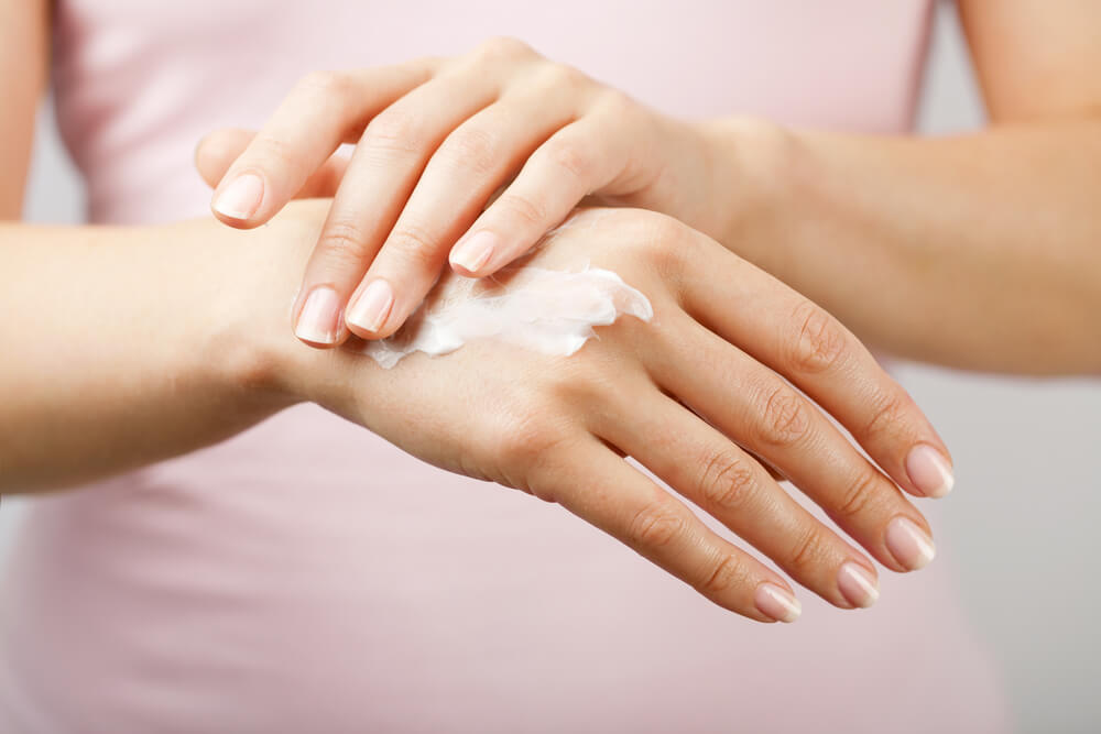 Woman applying hand cream