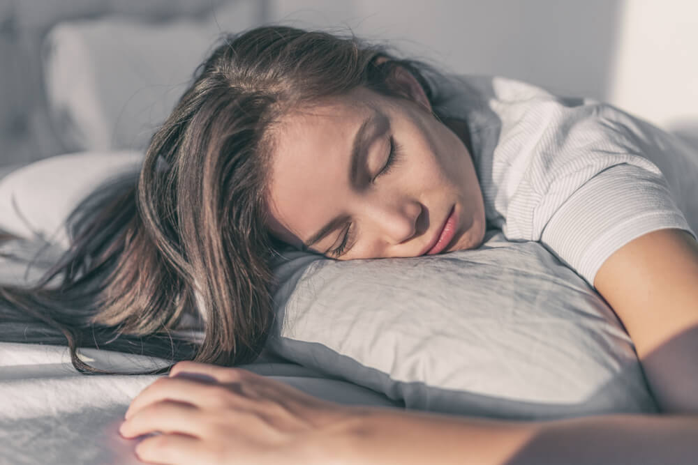 Woman sleeping on her front