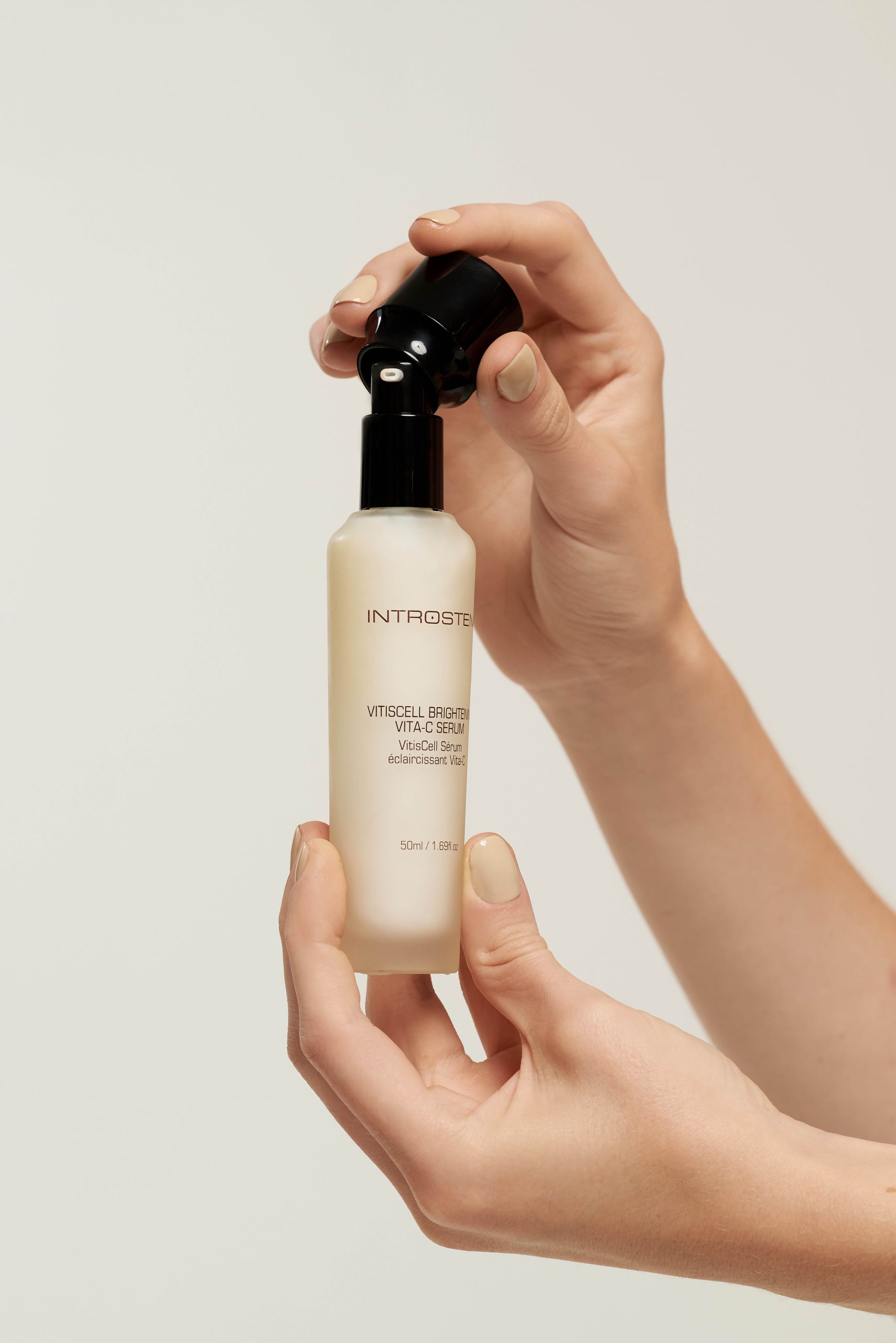 Woman opening Introstem Vita C Serum