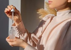 Woman using biotech skincare serum