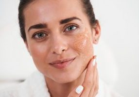 Woman using facial peeling gel