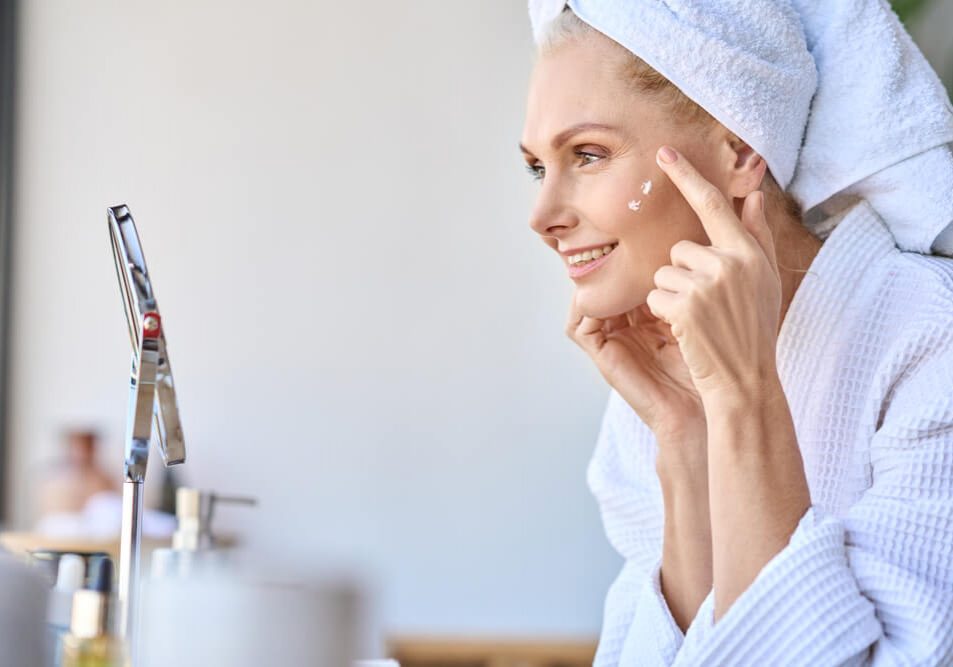 Woman applying cream after reading Introstem reviews