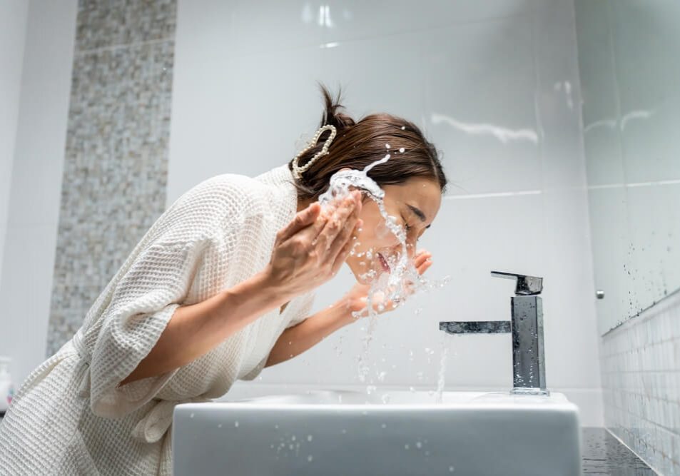 woman cleansing face