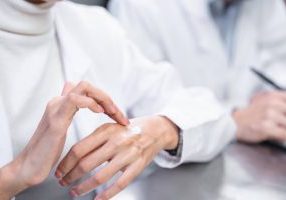 person applying cream on hand