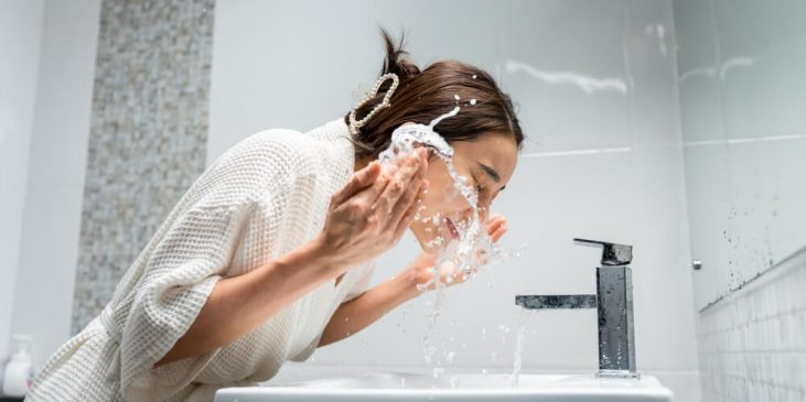 woman cleansing face