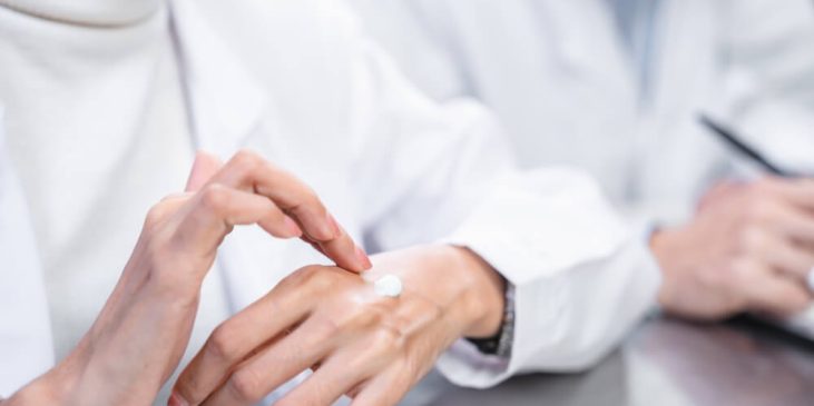 person applying cream on hand