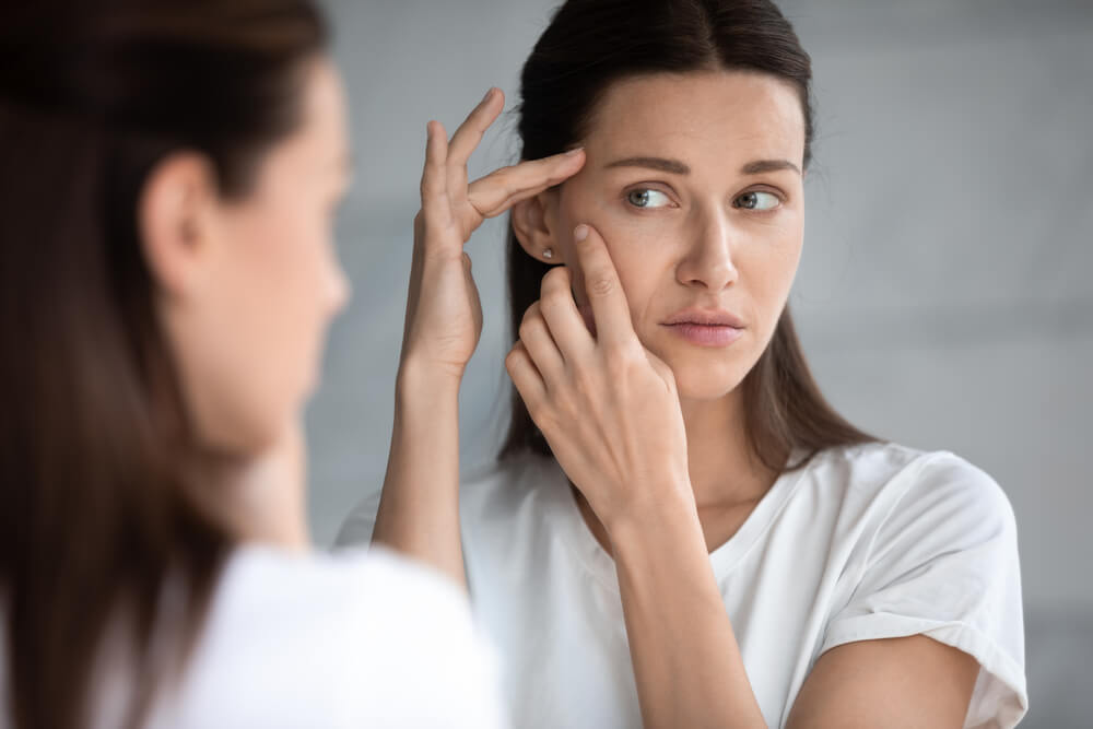 woman looking at wrinkles